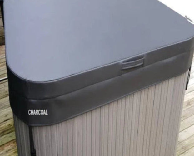 Hot tub with a charcoal-colored cover on a wooden deck